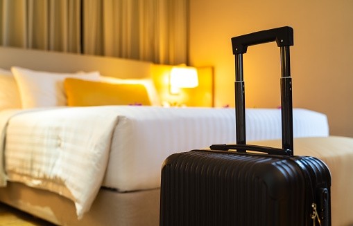 Suitcase delivered standing in hotel room. concept of Hotel service and travel